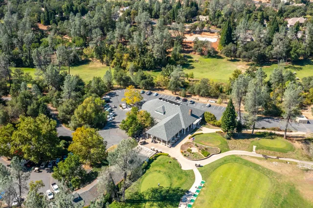 an aerial view of residential houses with outdoor space and swimming pool