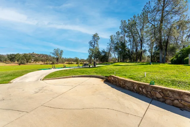 a swimming pool with an outdoor space and seating area