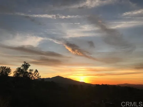 a view of an ocean and mountains
