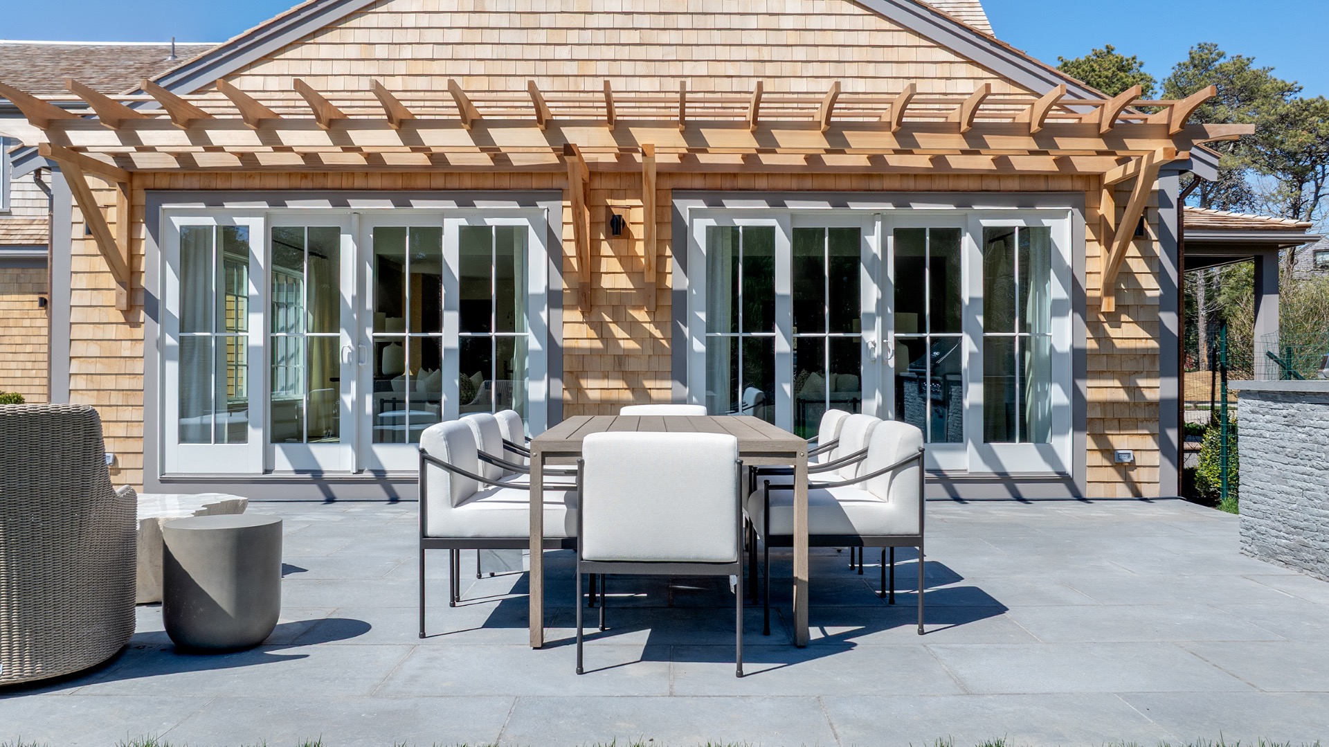 15 Deer Run Road Nantucket, MA 02554 - Photo 56 of 62 a view of a patio with a table and chairs and potted plants