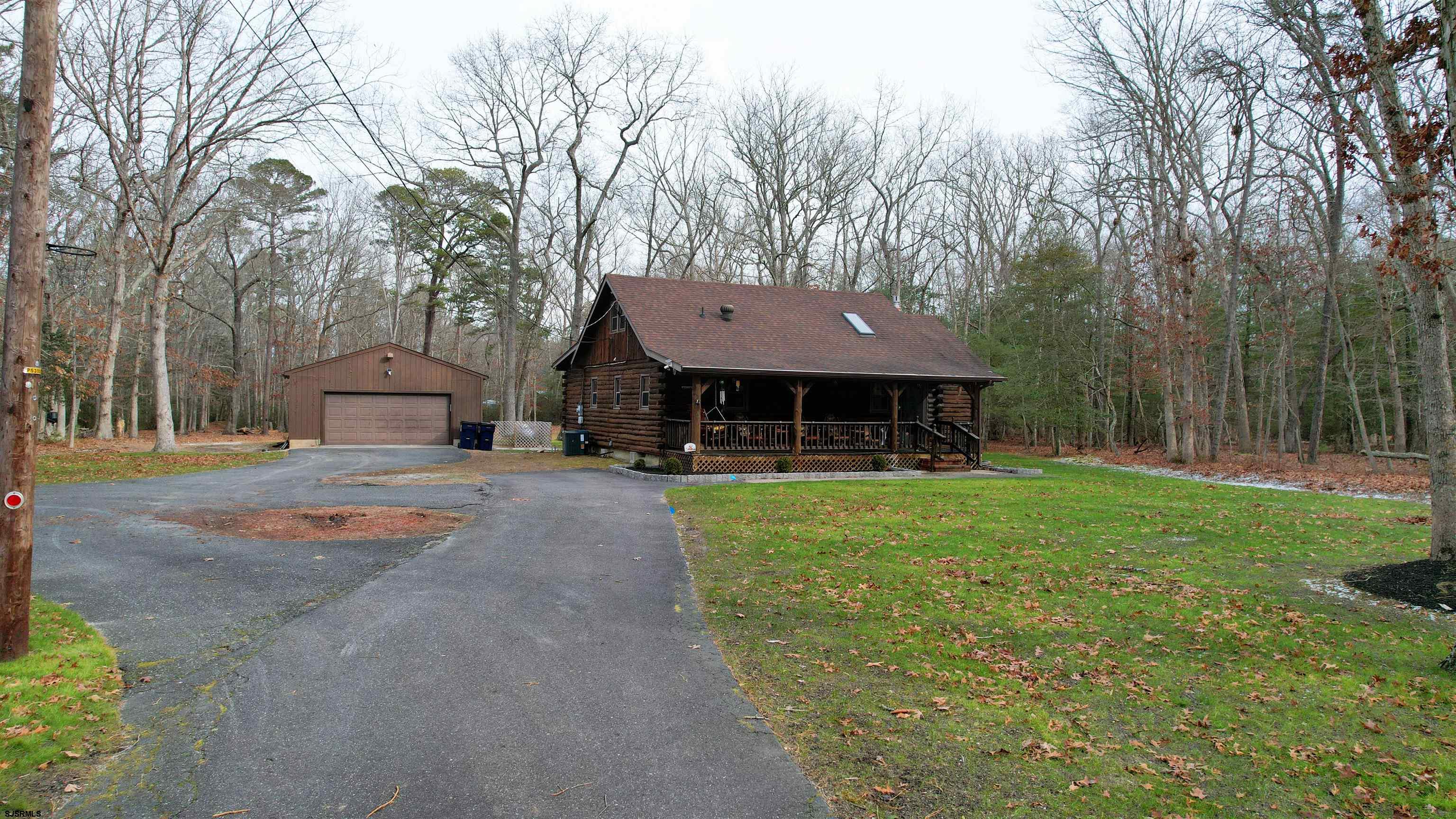 853 West Clarks Landing Road Galloway Township, NJ 08215 - Photo 3 of 64 a front view of a house with a garden and tree