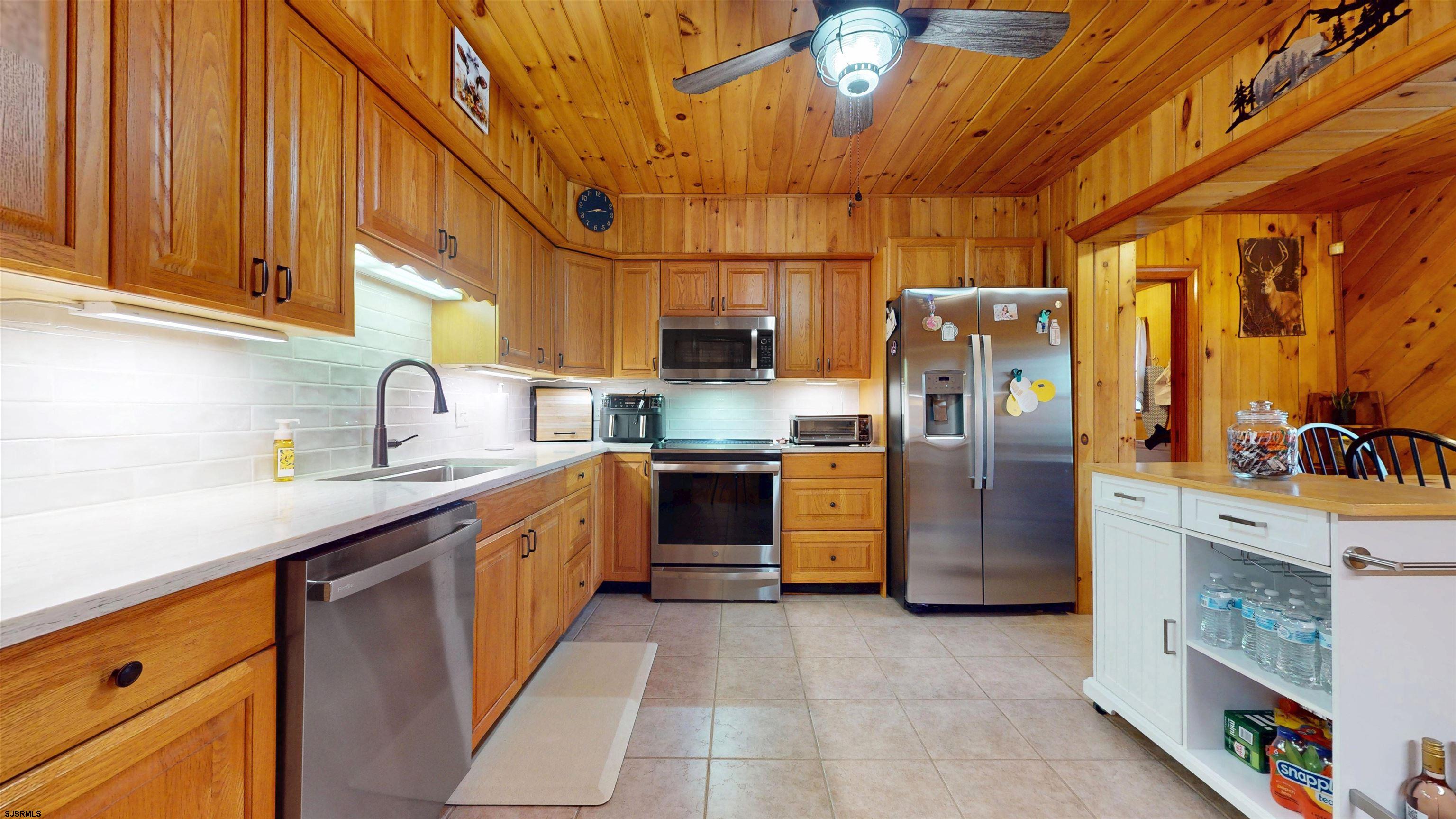 853 West Clarks Landing Road Galloway Township, NJ 08215 - Photo 37 of 64 a kitchen with stainless steel appliances a refrigerator a sink a stove and cabinets
