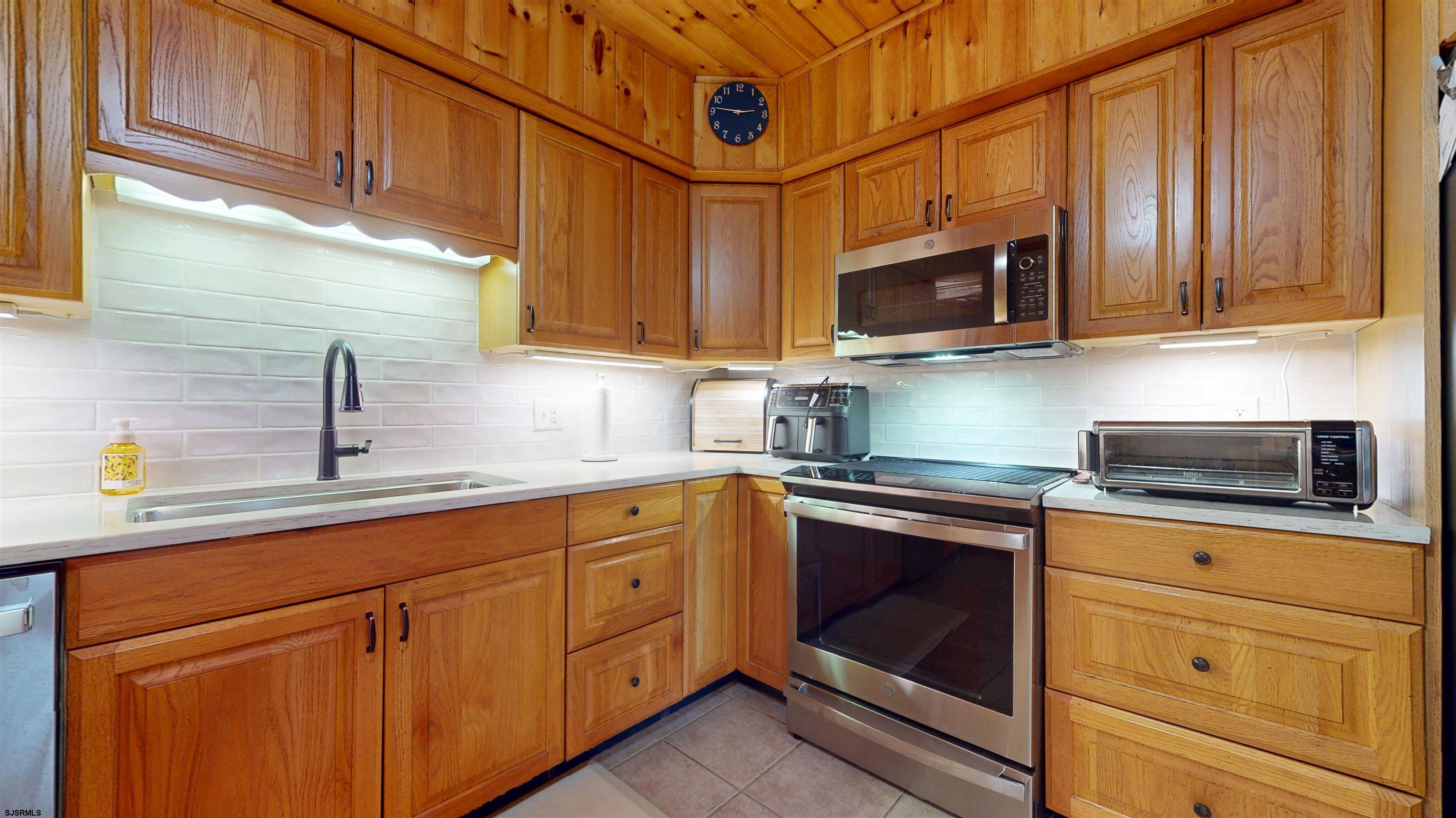 853 West Clarks Landing Road Galloway Township, NJ 08215 - Photo 39 of 64 a kitchen with stainless steel appliances granite countertop a sink stove and microwave