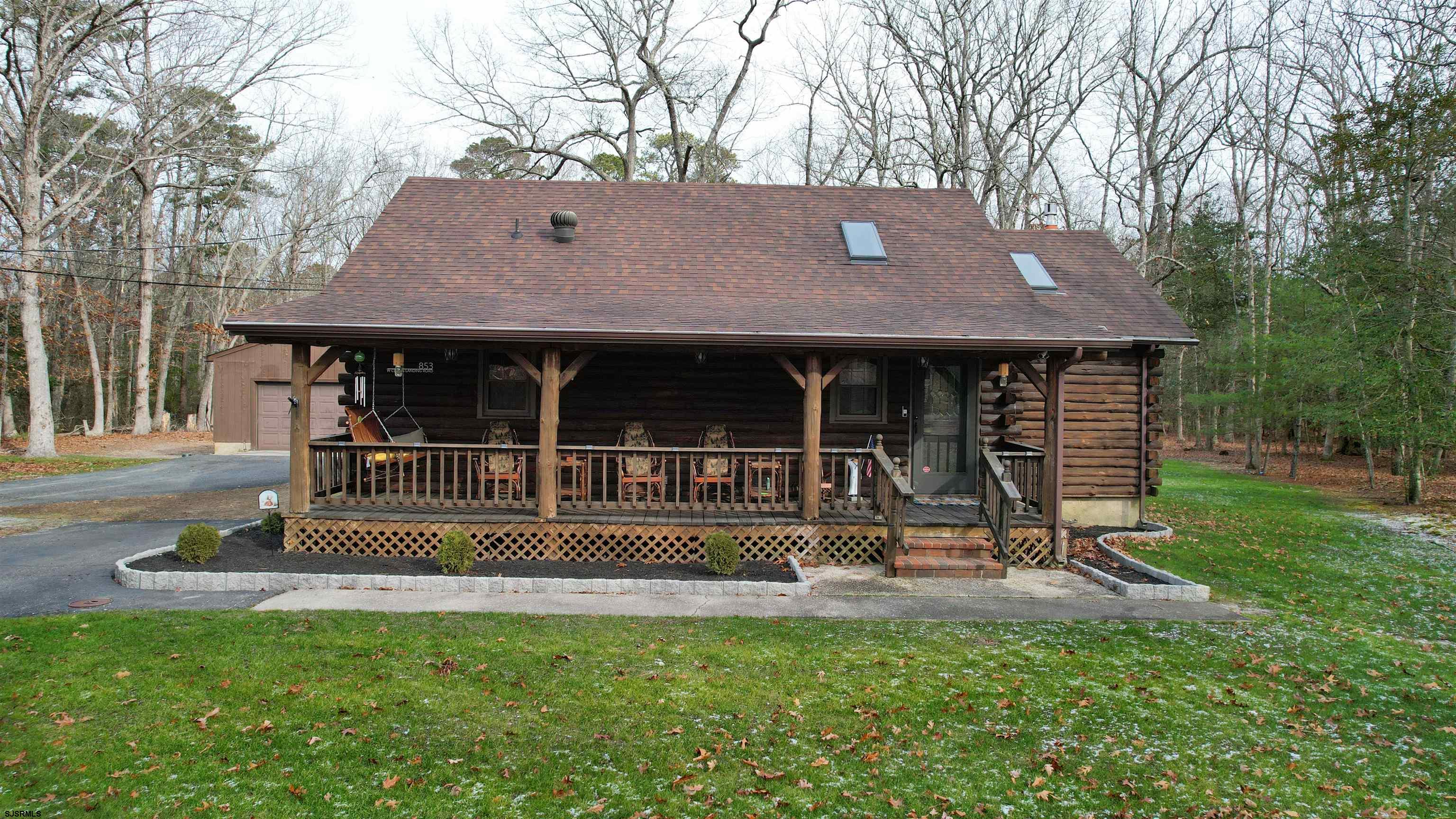 853 West Clarks Landing Road Galloway Township, NJ 08215 - Photo 4 of 64 a front view of a house with a yard table and chairs