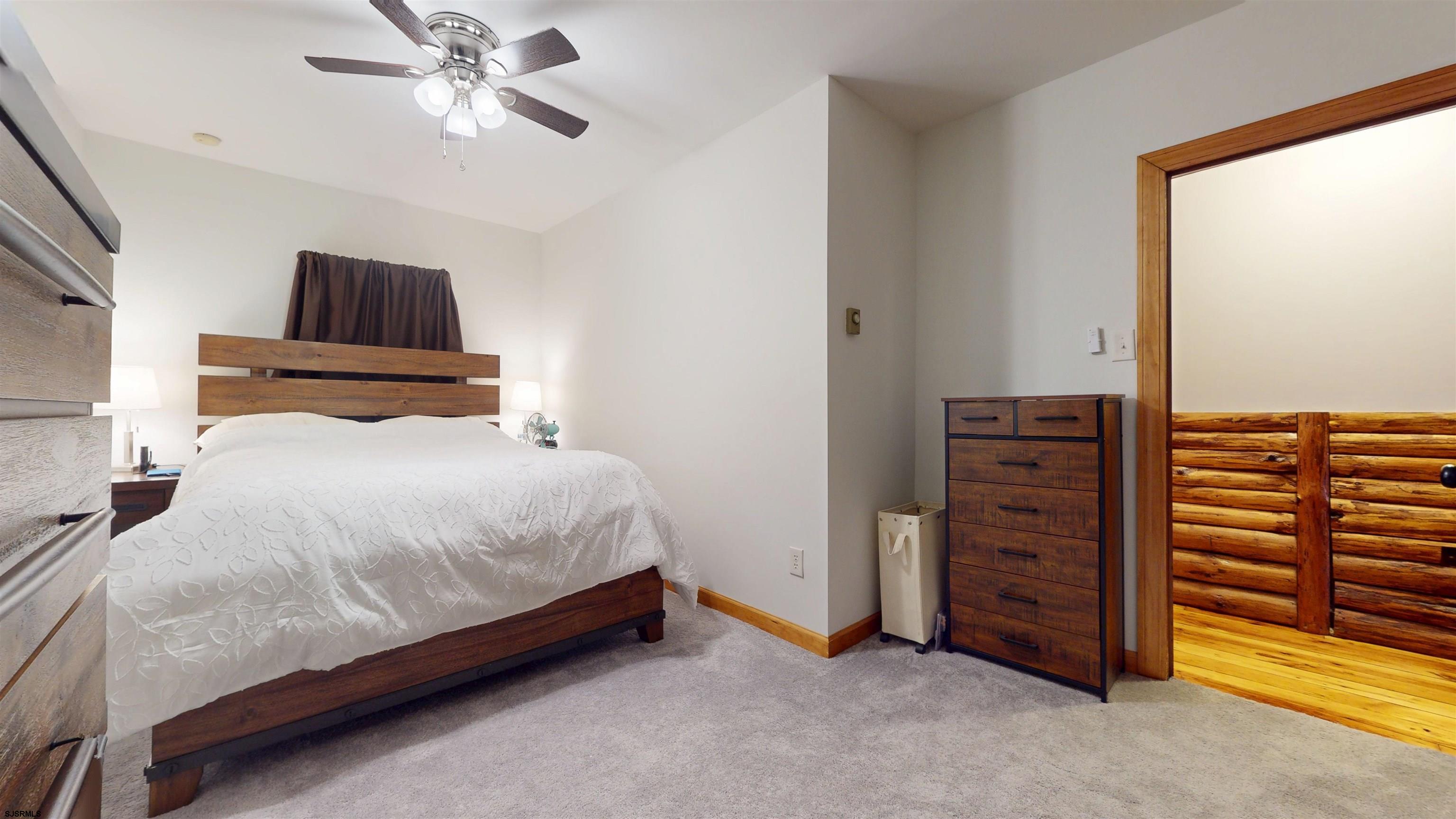 853 West Clarks Landing Road Galloway Township, NJ 08215 - Photo 52 of 64 a bedroom with a bed and a chandelier