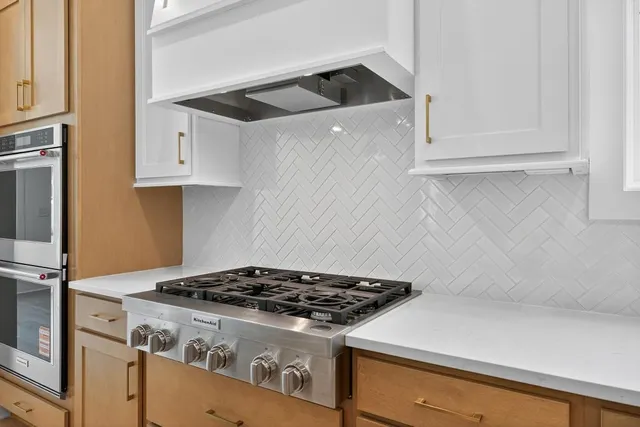 a stove top oven sitting inside of a kitchen