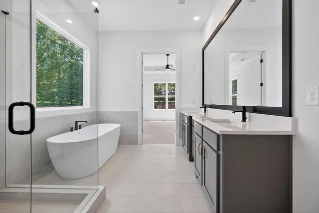 a spacious bathroom with a bathtub and sink