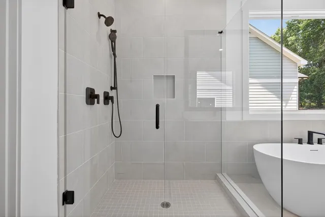 a bathroom with a bath tub and shower