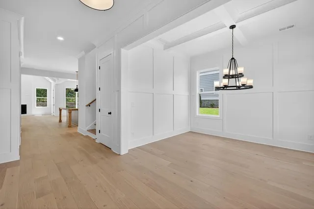 a view of a room with wooden floor and windows