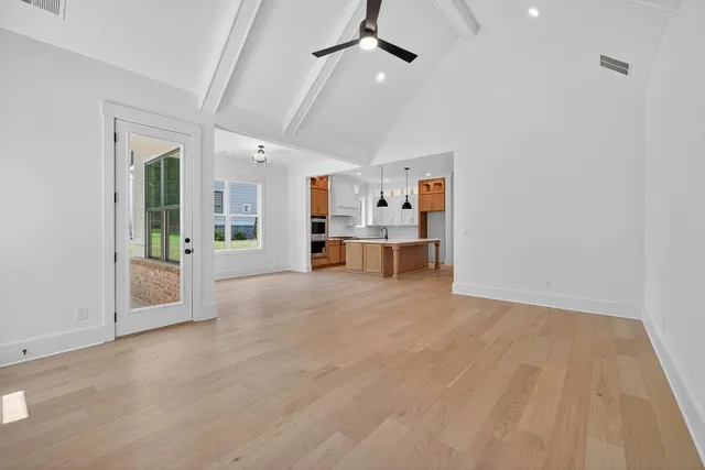 a view of a livingroom with furniture and a kitchen