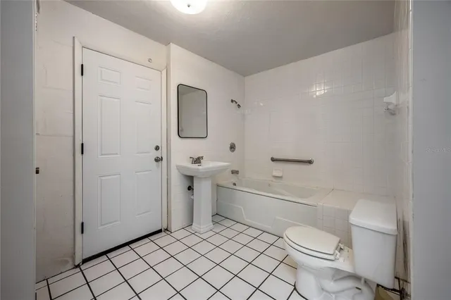 a bathroom with a toilet a sink and bathtub