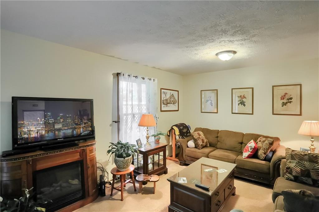 9250 Highland Road Pittsburgh, PA 15237 - Photo 2 of 25 The spacious living room/dining room combo allows for versatile furniture arrangement.