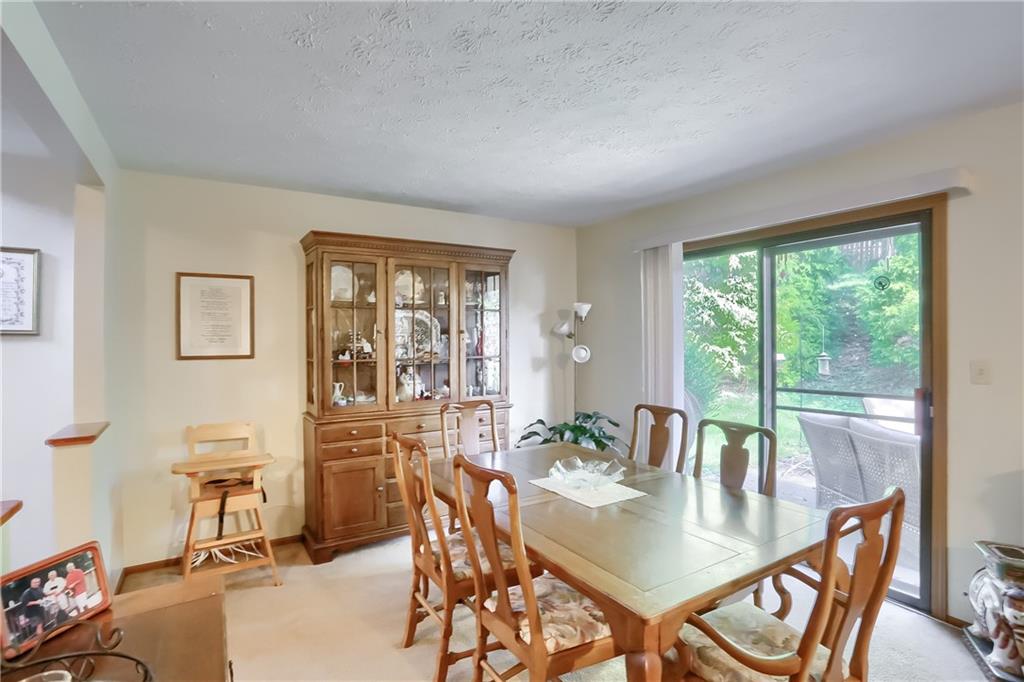 9250 Highland Road Pittsburgh, PA 15237 - Photo 6 of 25 The sliding glass door leads to a private patio that overlooks the beautiful back yard.