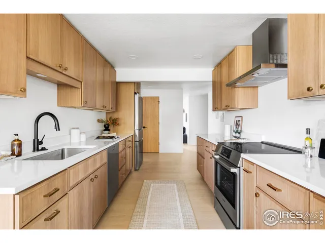 a kitchen with sink a stove and cabinets
