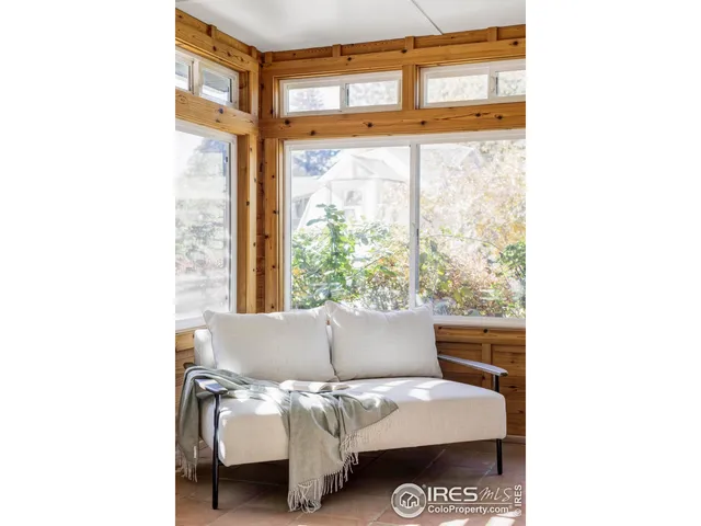 a view of a living room with a bed and a window