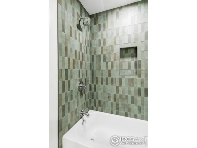 a bathroom with a bathtub and shower