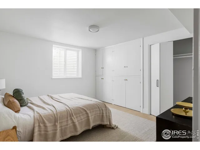 a bedroom with a bed and a desk