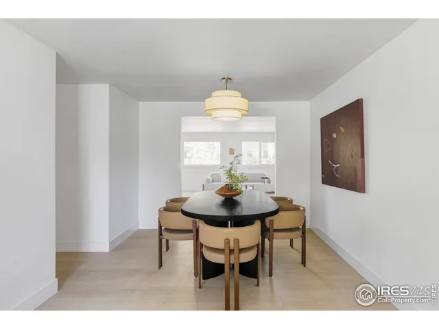 a view of a dining room with furniture and a chandelier