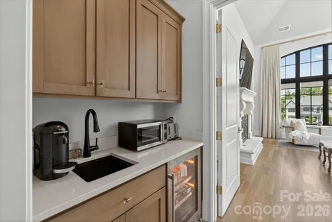a view of a kitchen with stainless steel appliances granite countertop a refrigerator and a sink