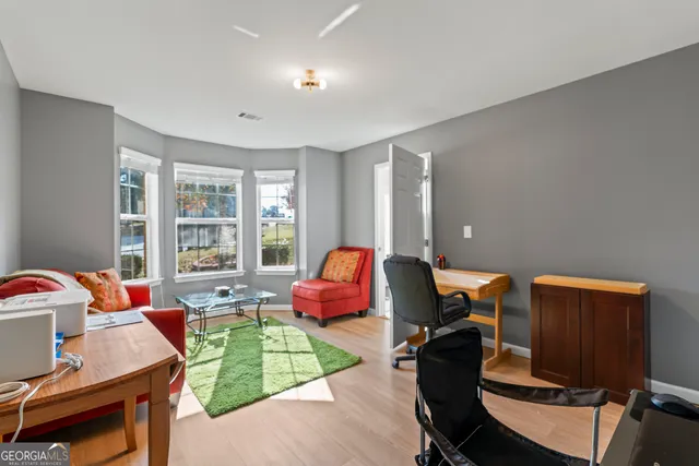 a view of a dining room with furniture and a chandelier