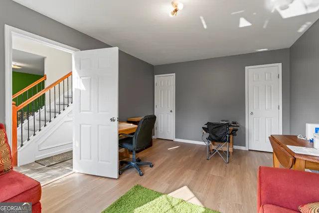 a kitchen with stainless steel appliances kitchen island granite countertop a refrigerator stove top oven dining table and chairs