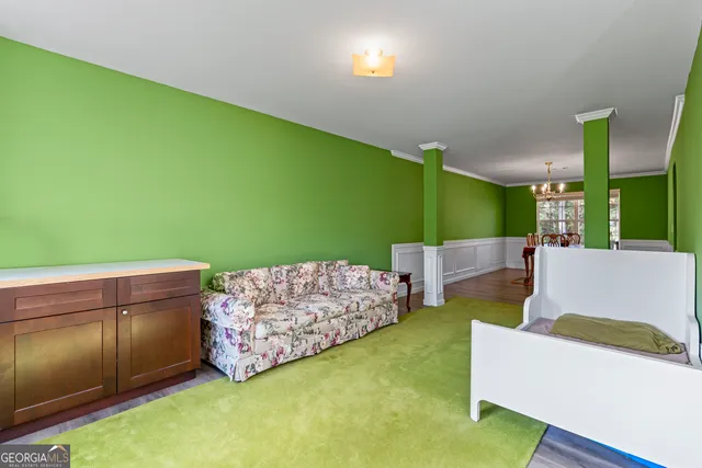 a kitchen with stainless steel appliances kitchen island granite countertop a refrigerator and a dining table