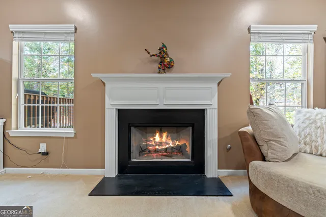 a view of a backyard with large trees and wooden fence