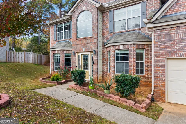 a front view of a house with garden