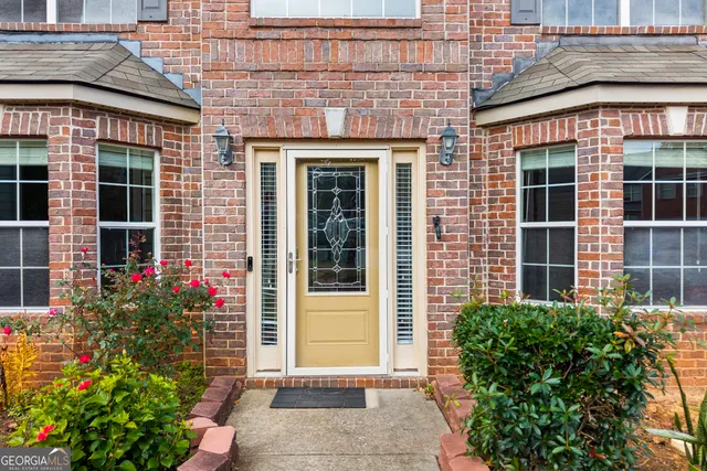 a view of staircase with lots of frames on wall and wooden floor