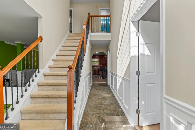 a view of entryway and hall with wooden floor