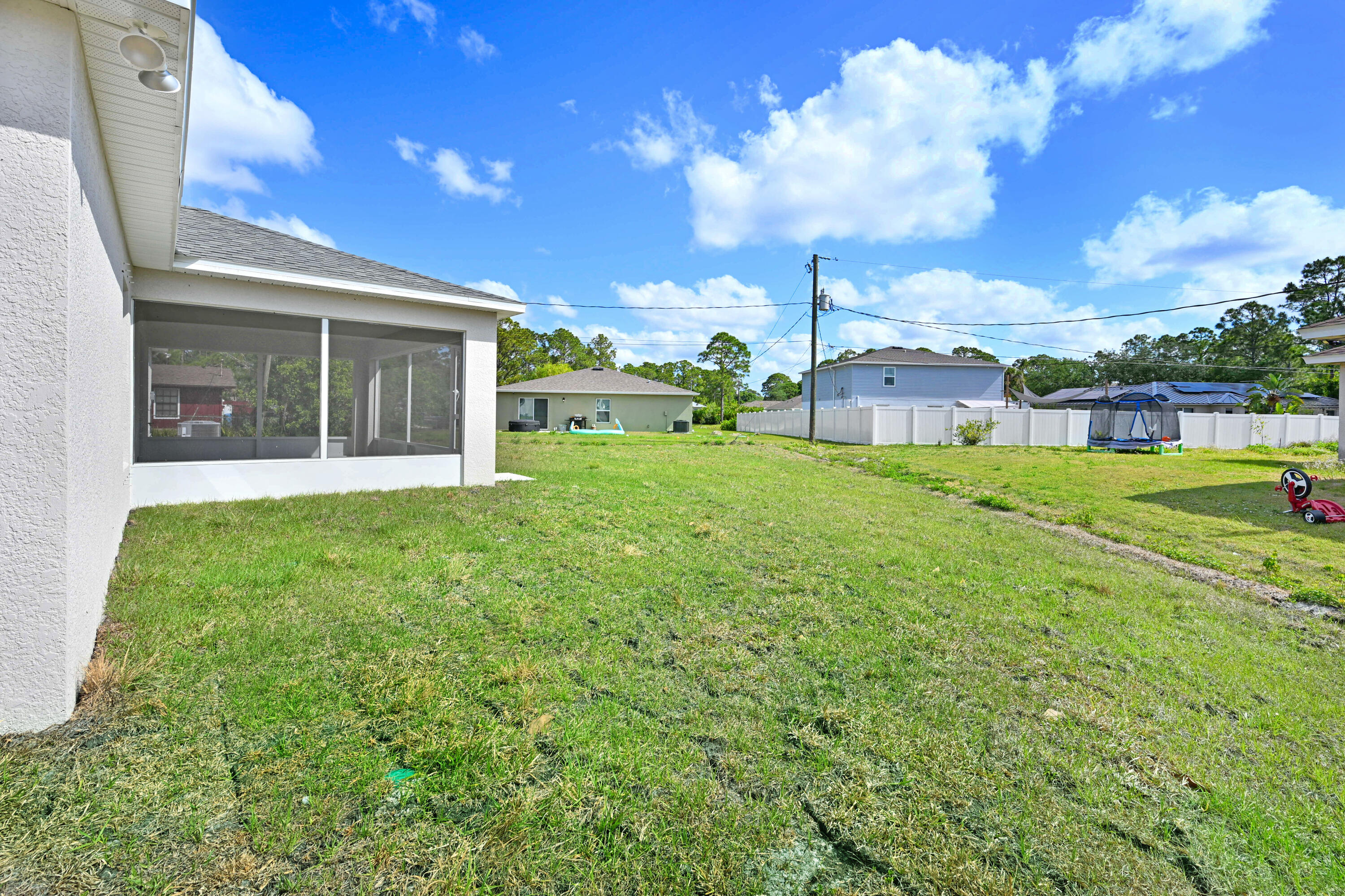 239 Trilby Road Southwest Palm Bay, FL 32908 - Photo 34 of 38 a view of a house with a big yard and potted plants