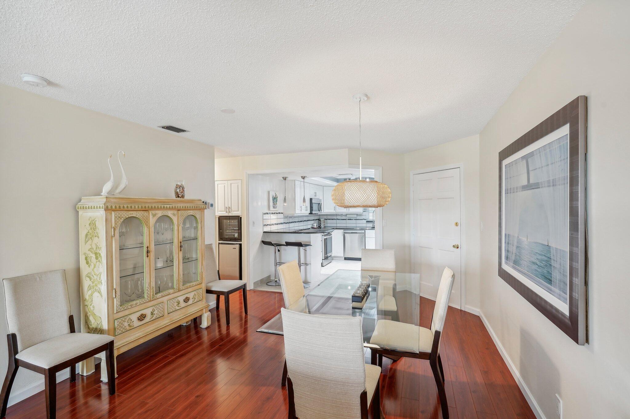 5540 North Ocean Boulevard, Unit 212 Ocean Ridge, FL 33435 - Photo 13 of 41 a view of a dining room with furniture window and wooden floor