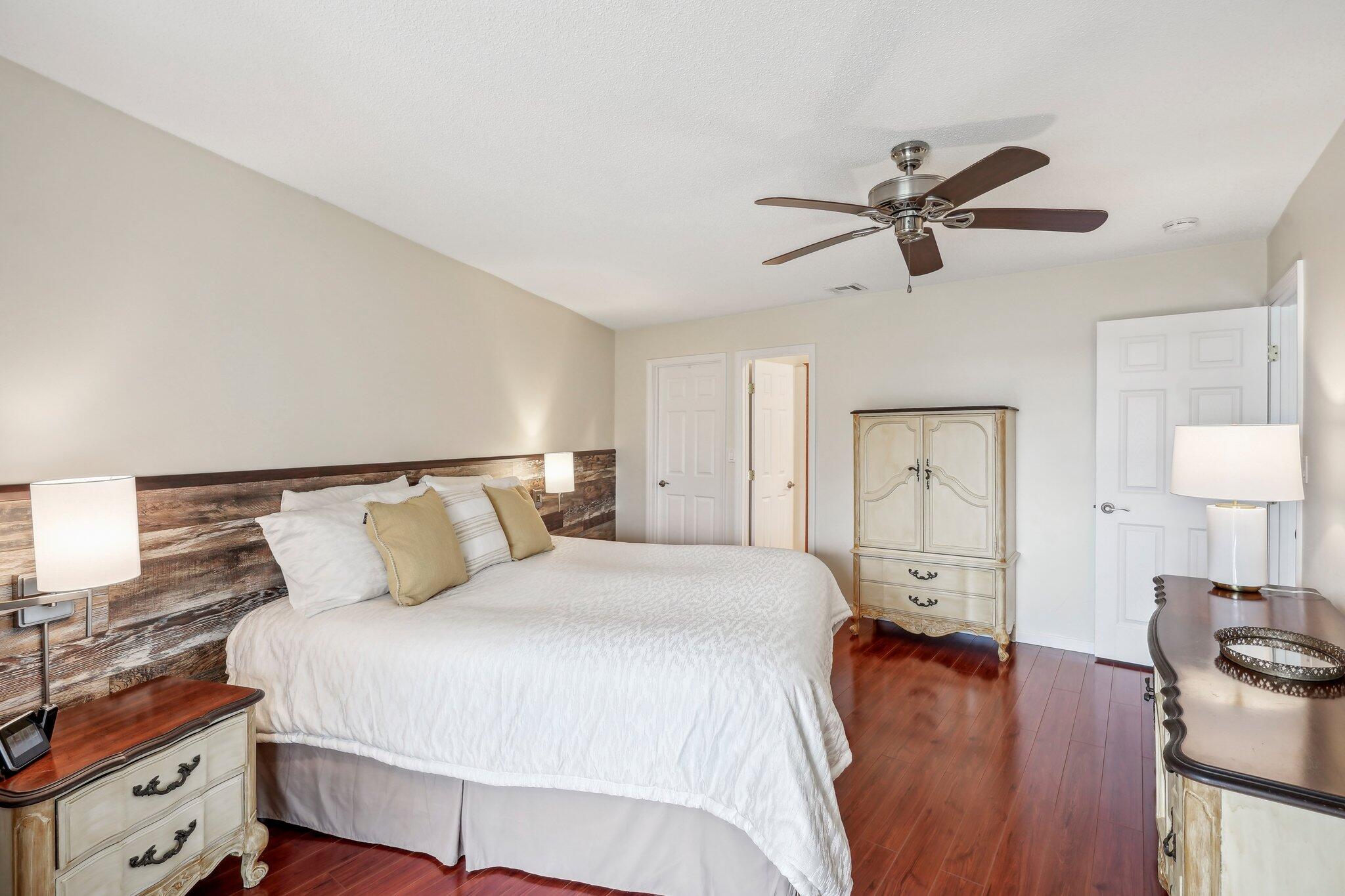 5540 North Ocean Boulevard, Unit 212 Ocean Ridge, FL 33435 - Photo 14 of 41 a bedroom with a bed and wooden floor