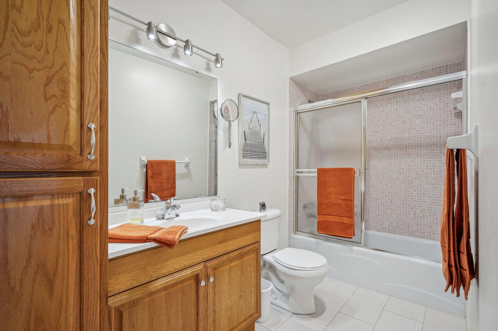 5540 North Ocean Boulevard, Unit 212 Ocean Ridge, FL 33435 - Photo 15 of 41 a bathroom with a sink a toilet and shower