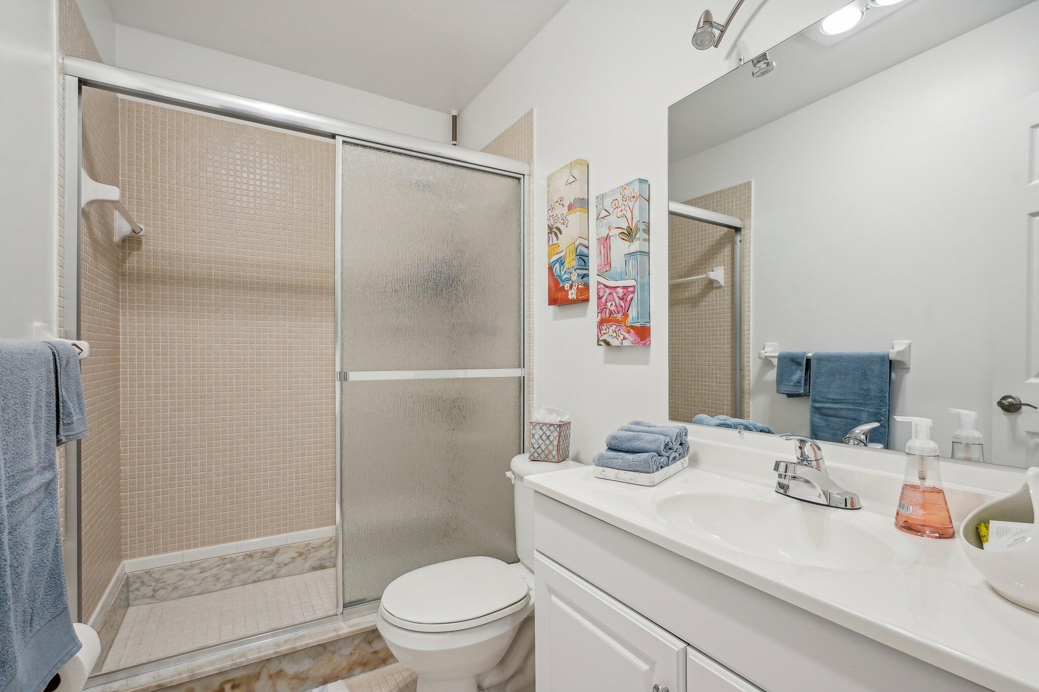 5540 North Ocean Boulevard, Unit 212 Ocean Ridge, FL 33435 - Photo 17 of 41 a bathroom with a sink toilet and shower