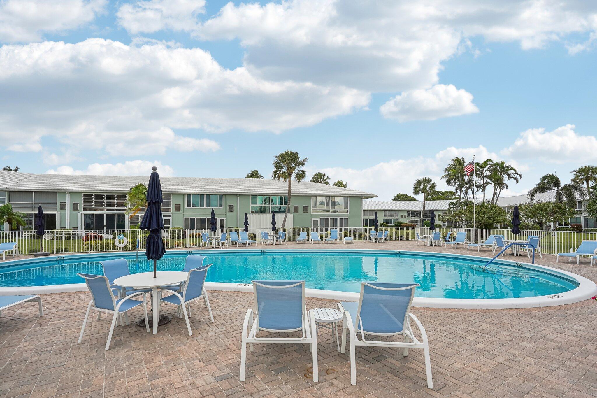 5540 North Ocean Boulevard, Unit 212 Ocean Ridge, FL 33435 - Photo 21 of 41 a view of a swimming pool and a back yard
