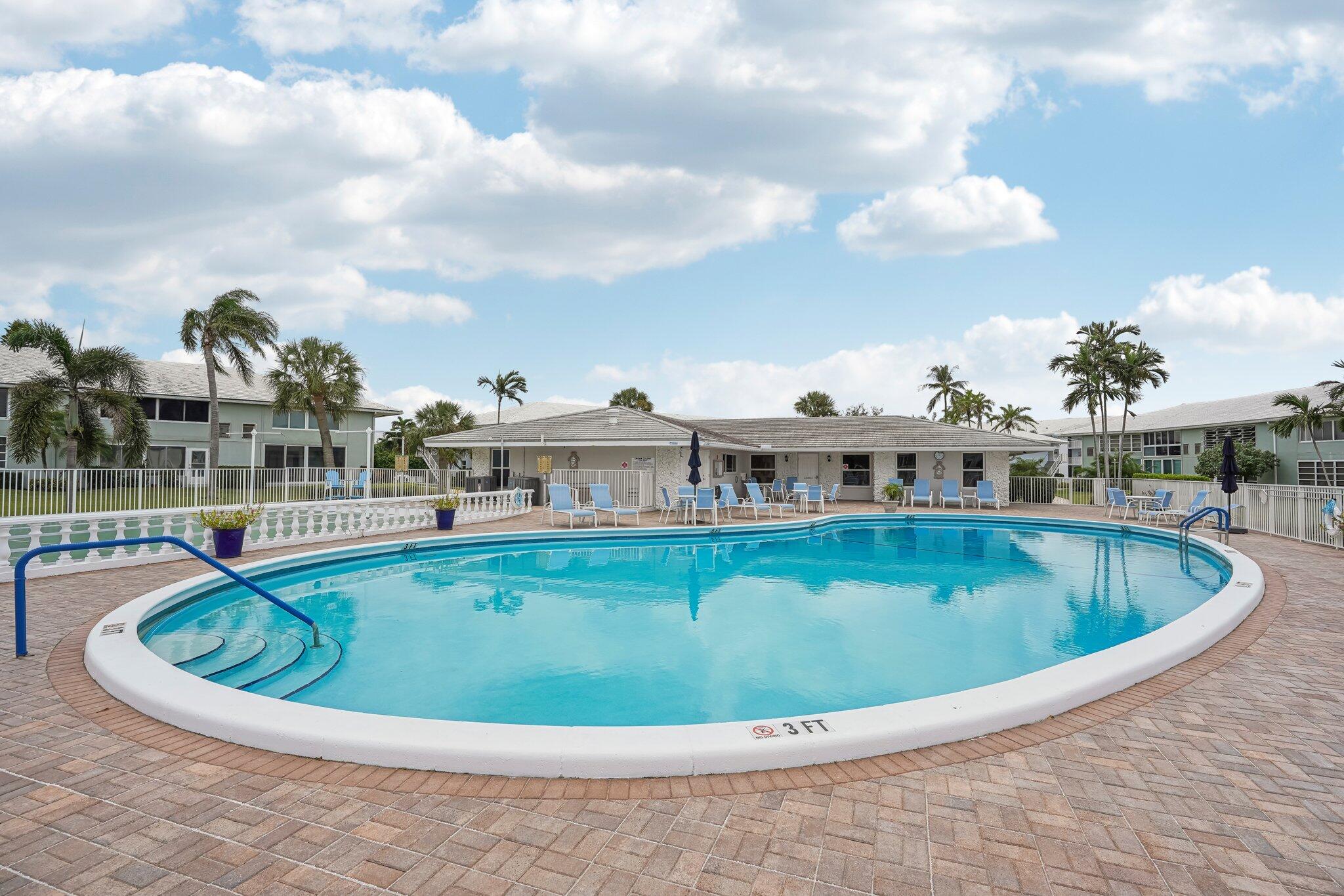 5540 North Ocean Boulevard, Unit 212 Ocean Ridge, FL 33435 - Photo 25 of 41 a view of a swimming pool with a terrace