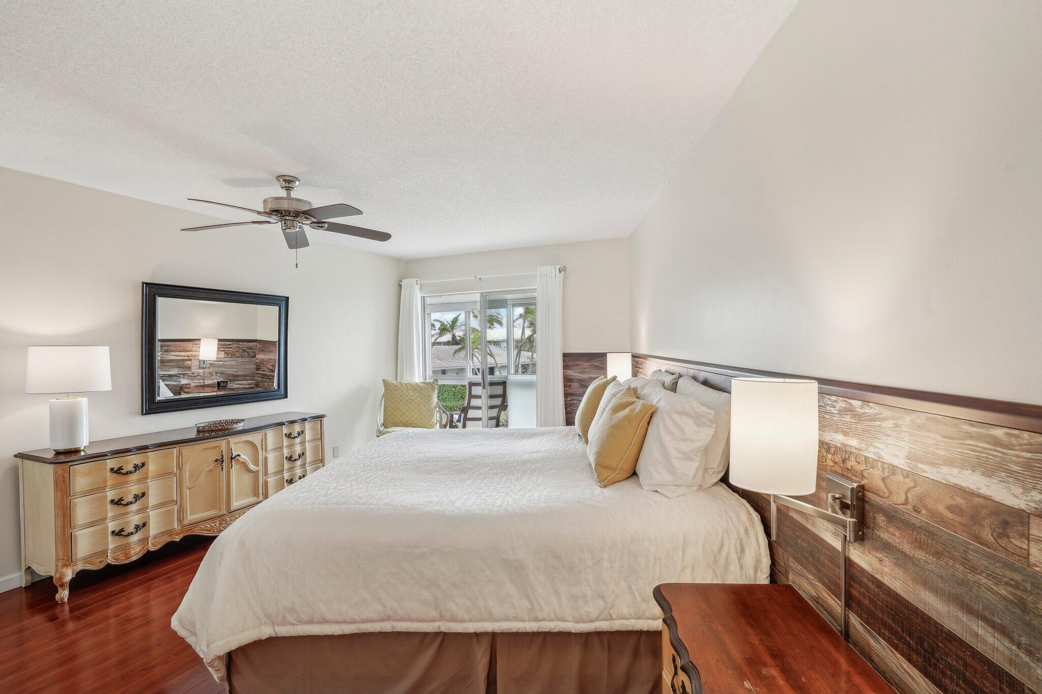 5540 North Ocean Boulevard, Unit 212 Ocean Ridge, FL 33435 - Photo 5 of 41 a bedroom with a bed and a flat screen tv
