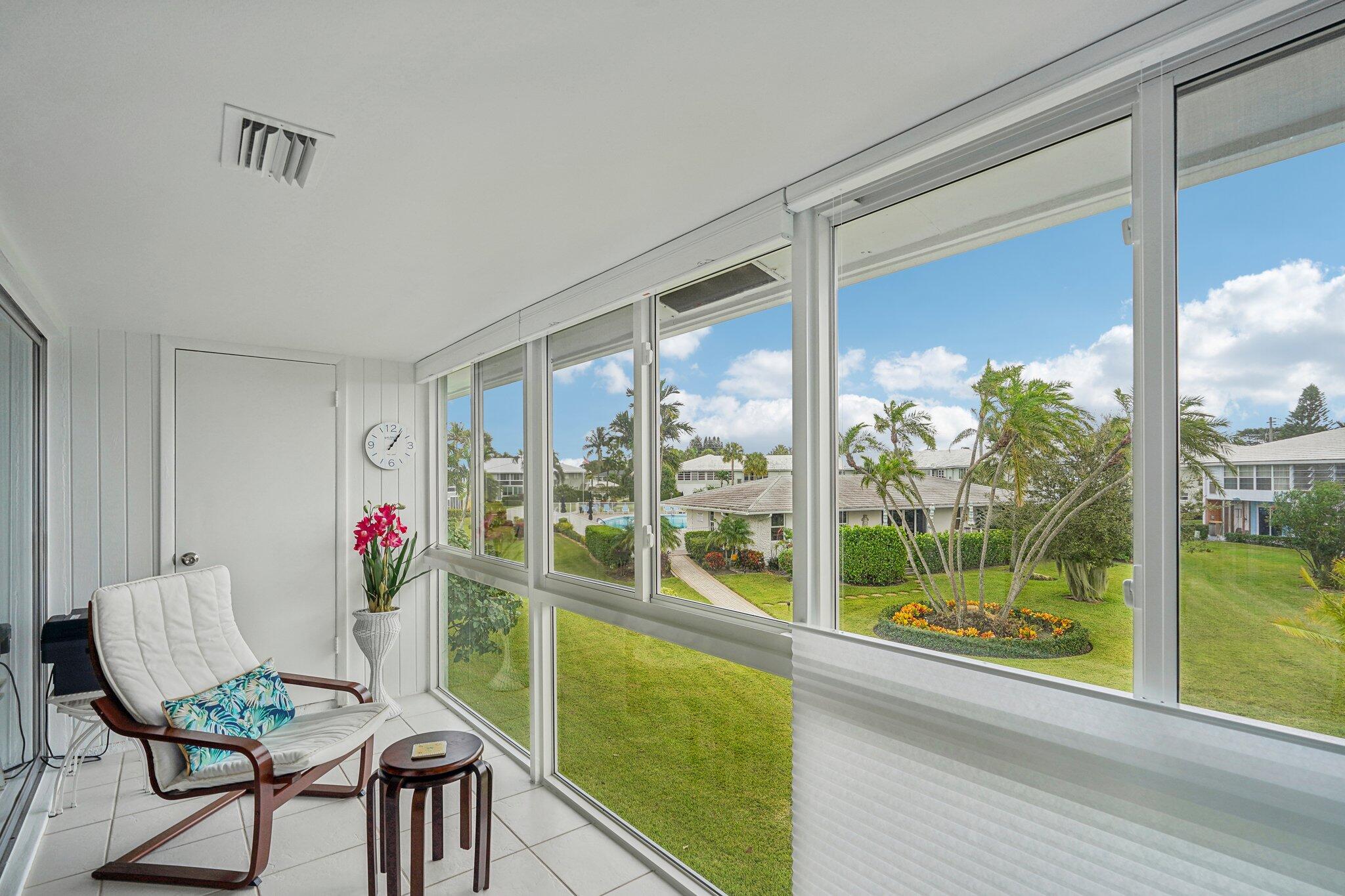 5540 North Ocean Boulevard, Unit 212 Ocean Ridge, FL 33435 - Photo 7 of 41 a view of a living room with furniture and floor to ceiling windows