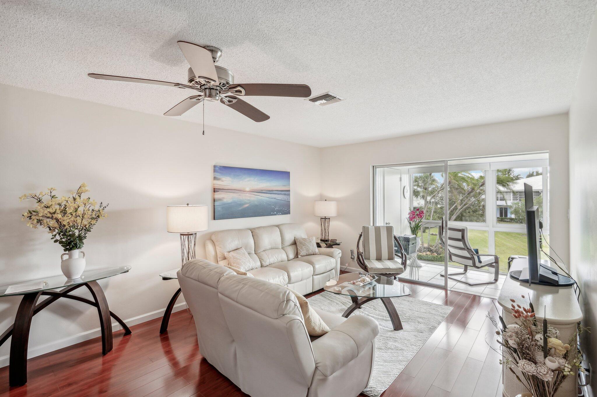 5540 North Ocean Boulevard, Unit 212 Ocean Ridge, FL 33435 - Photo 10 of 41 a living room with furniture and a floor to ceiling window
