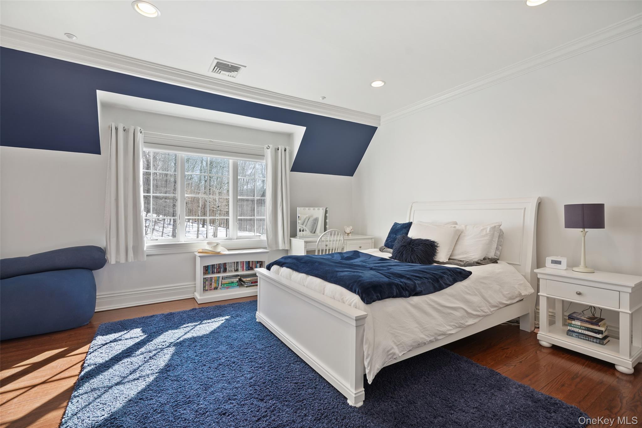 26 Hollow Ridge Road Bedford Corners, NY 10549 - Photo 19 of 39 a spacious bedroom with a bed a couch and large window