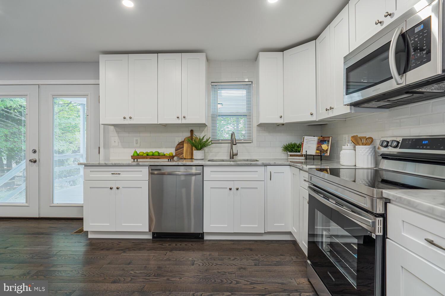 9020 Moonstone Road Baltimore, MD 21236 - Photo 12 of 30 a kitchen with stainless steel appliances granite countertop a stove a sink and a microwave