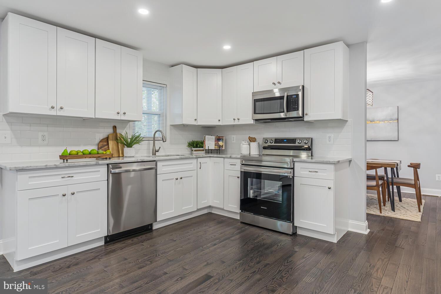9020 Moonstone Road Baltimore, MD 21236 - Photo 13 of 30 a kitchen with granite countertop white cabinets and stainless steel appliances