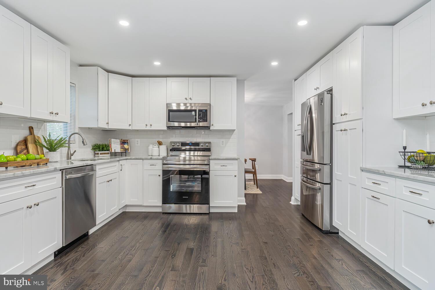 9020 Moonstone Road Baltimore, MD 21236 - Photo 14 of 30 a kitchen with white cabinets and stainless steel appliances