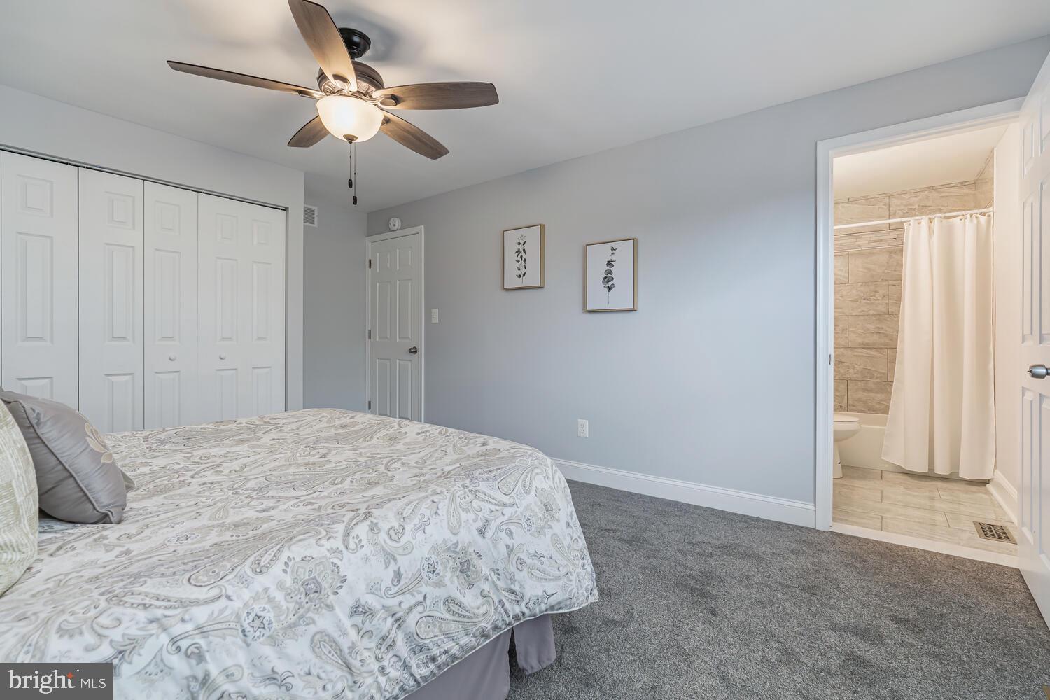 9020 Moonstone Road Baltimore, MD 21236 - Photo 21 of 30 a bedroom with a bed and a chandelier