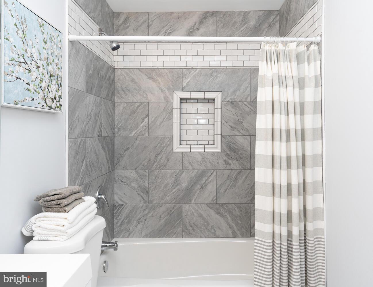 9020 Moonstone Road Baltimore, MD 21236 - Photo 25 of 30 a bathroom with a bathtub and shower