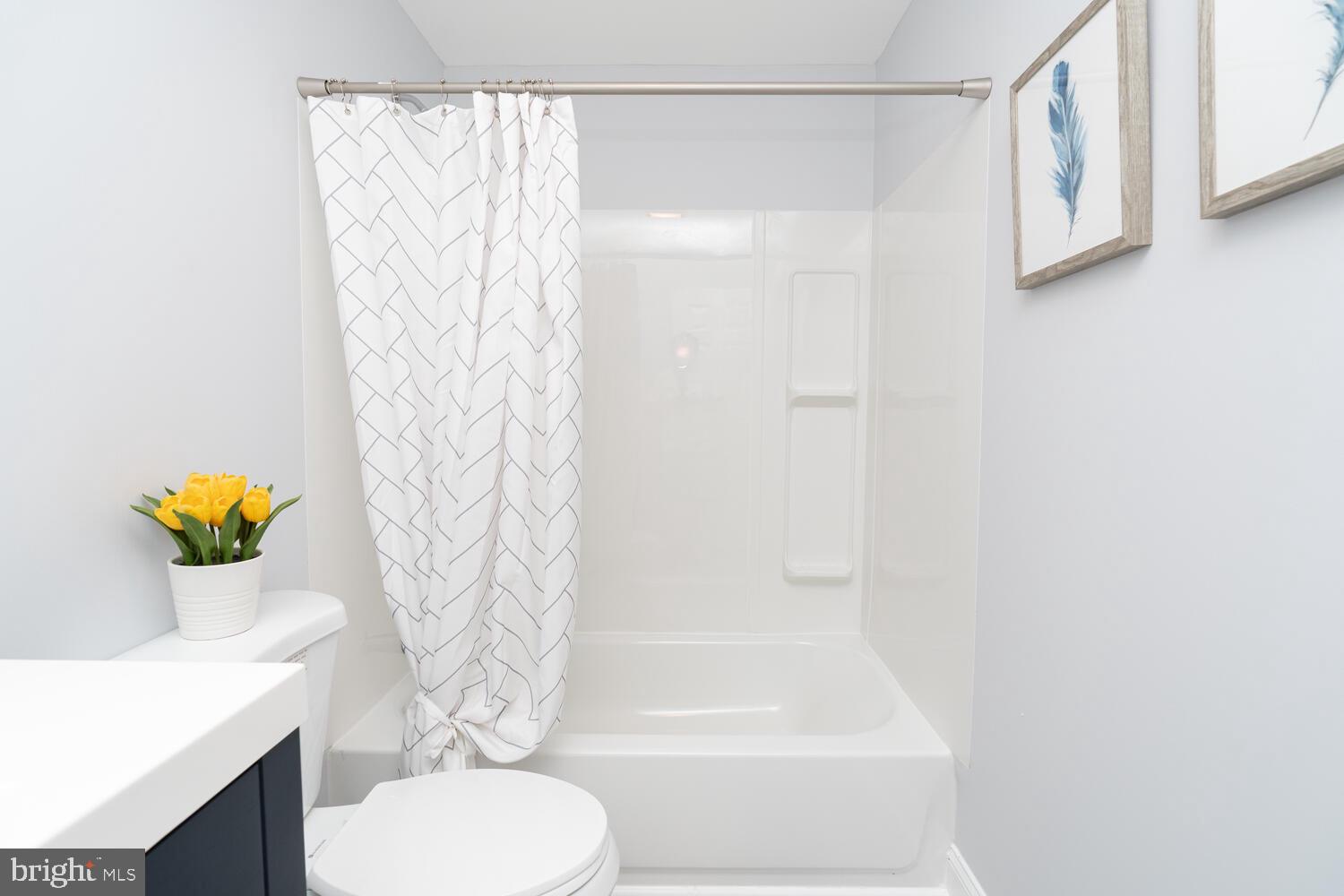 9020 Moonstone Road Baltimore, MD 21236 - Photo 29 of 30 a bathroom with a toilet and a shower curtain