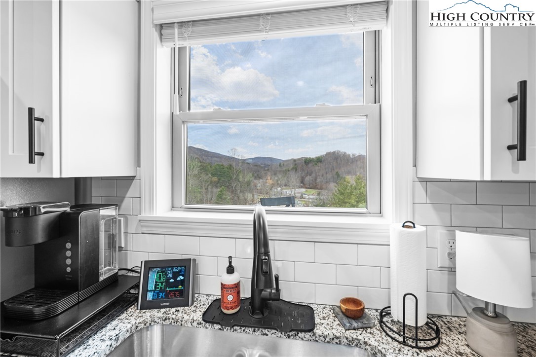 513 Townhomes Place, Unit 27 Boone, NC 28607 - Photo 15 of 33 a kitchen with a window a sink and a counter top space