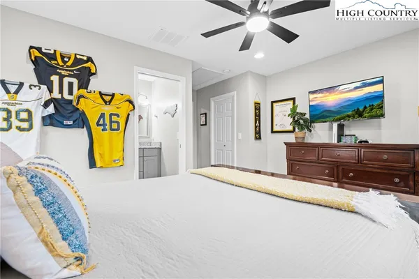 a bedroom with a bed and a flat screen tv