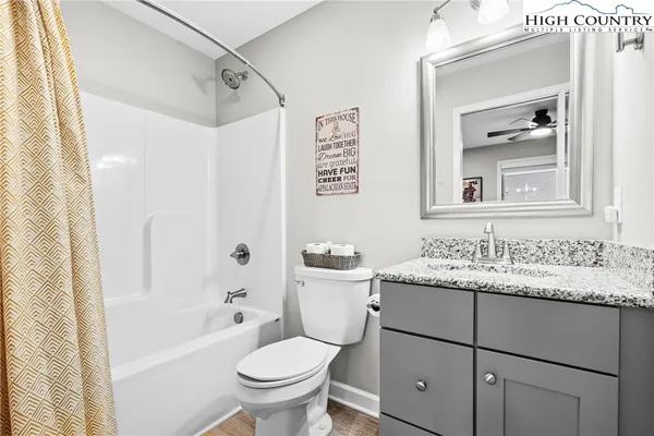 a bathroom with a sink toilet vanity and shower
